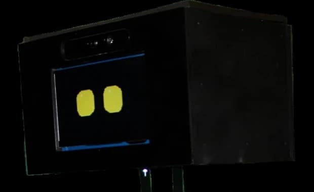Close-up of Orio's head: a depth camera above a screen face showing two yellow eyes